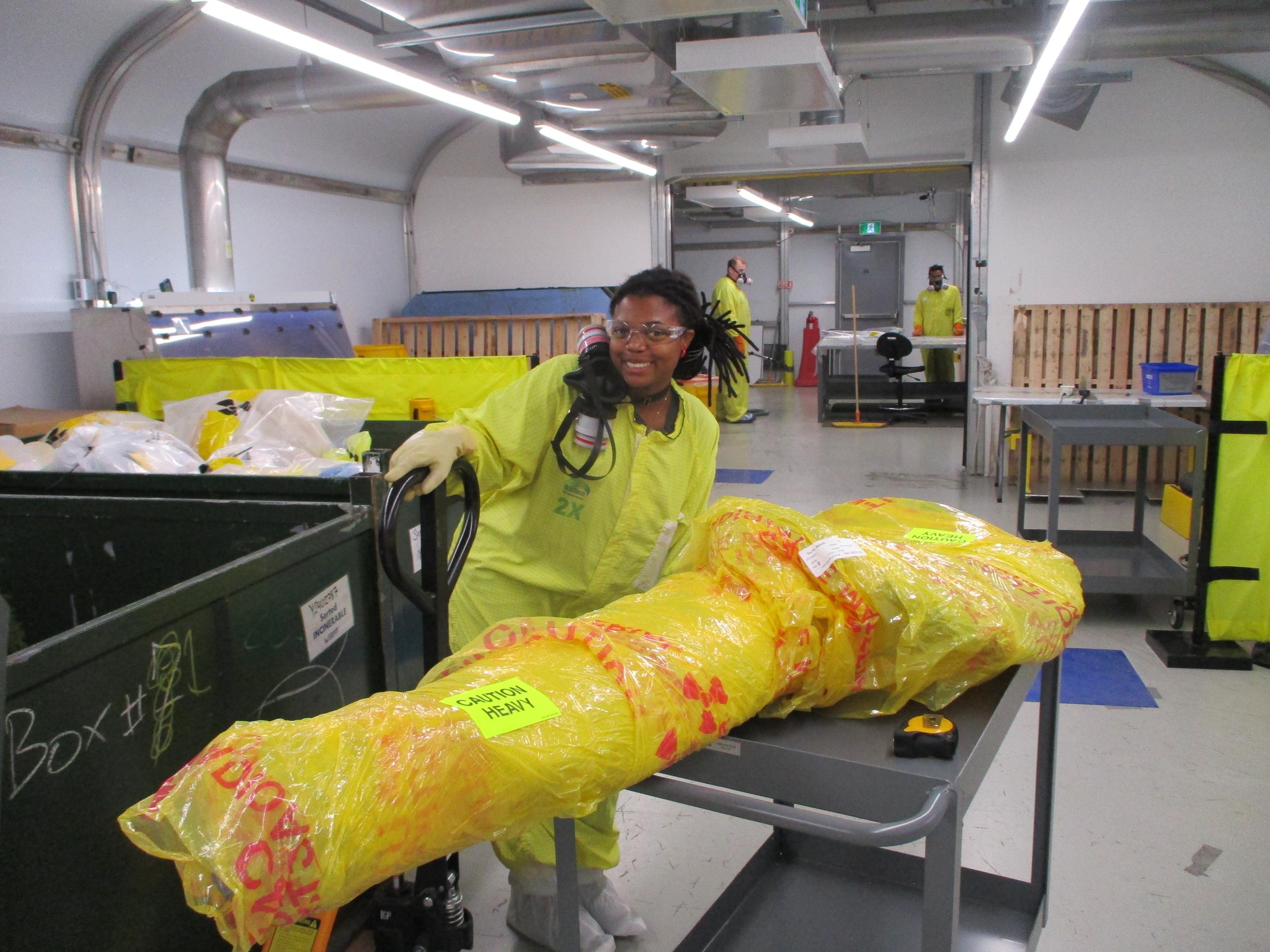 Laurentis's Yanique Bradford surveying material at the Clean-Energy Sorting and Recycling Facility in Hamilton, ON